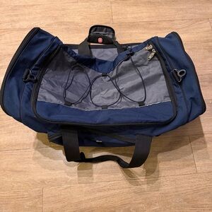 Navy and grey duffel bag with multiple pockets and adjustable straps